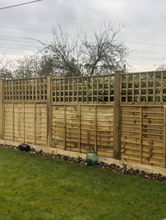 Traditional overlapping timber fence panels with integrated trellis tops