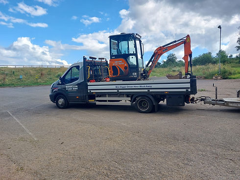 Digger machine loaded on a commercial vehicle for transport