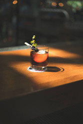 Whiskey garnished with fresh herbs