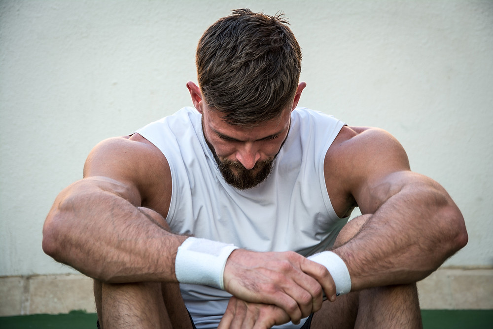 tired athlete male gymnast