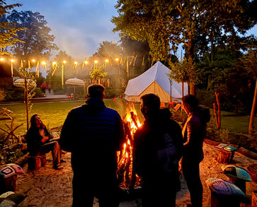 Group of participants gathered around a campfire at Elevated Mind Retreats, enjoying connection and reflection