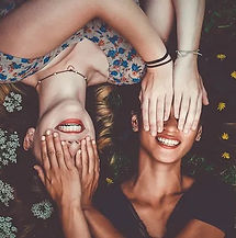 Two women holding hands before eyes