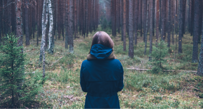 Person walking through nature reflecting on whether a psilocybin retreat is right for them.