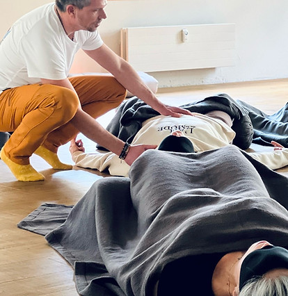 Facilitator supporting a participant during a breathwork session at elevated mind retreats
