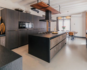 Modern retreat kitchen with private chef preparing healthy vegetarian meals.