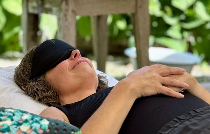 Participant during a guided psilocybin retreat experiencing deep relaxation and self-reflection