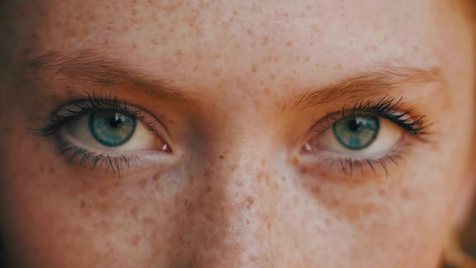 Women's face with freckles and green eyes