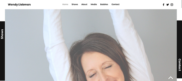 Cover page for WendyLiebman.com showing Wendy wearing a white shirt with arms in the air and a smile on her face