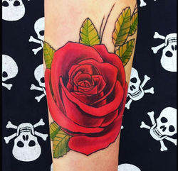 A vibrant red rose tattoo