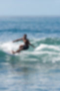 Balinese surf instructor surfing in Bali