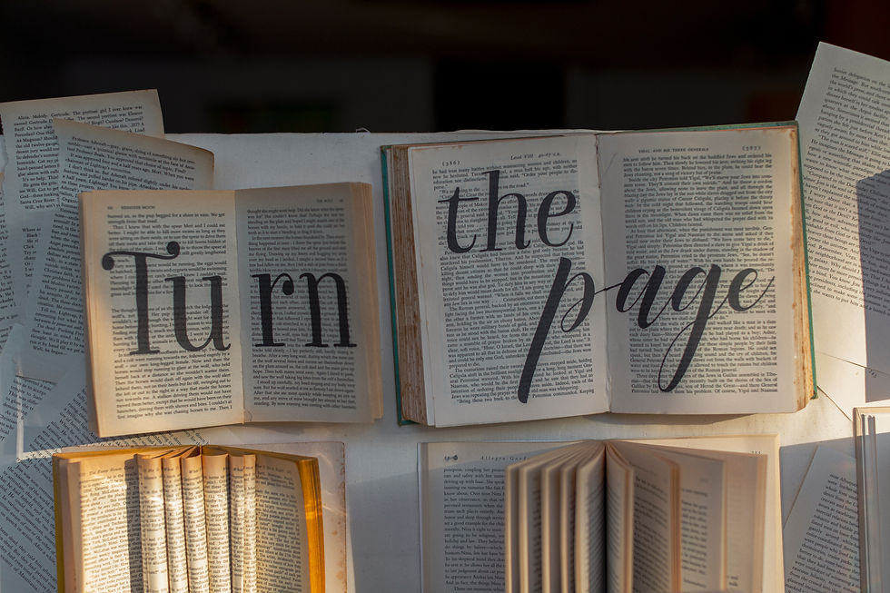 A collection of older books, with the words Turn the Page written across them in bold black lettering