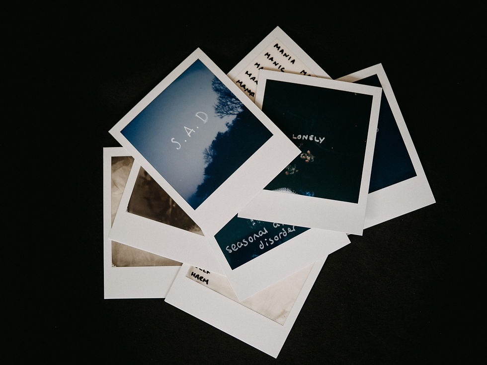 Polaroid photos on a black background. The top one says "Sad" on a moody night blue sky.