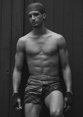 Shirtless male model with a toned physique, featured in men model management's black and white portfolio