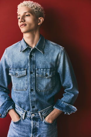 Model in light blue denim shirt and jeans