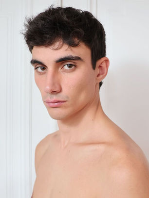 Young man looking at the camera, no visible text, portrait style, MGMT agency