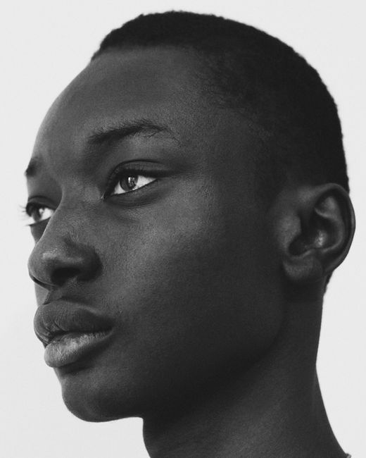 Close-up black and white portrait of a young Black man