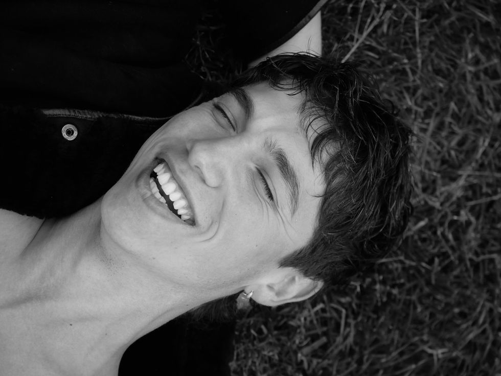 Smiling model lying on grass