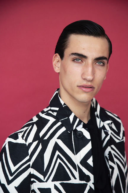 Portrait of male model Mario Valdi wearing graphic black and white jacket – professional male modeling by Men Model MGMT Paris