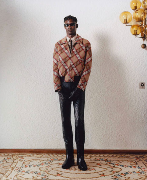 Model in plaid jacket and black pants