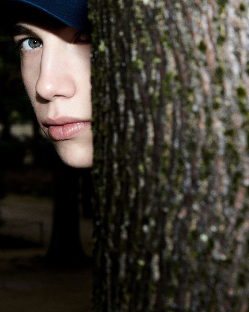 Model partially hidden, blue cap