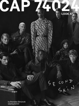 Ismael Savane featured on the cover of CAP 74024 magazine, photographed in a black and white editorial alongside other models, wearing Gucci.