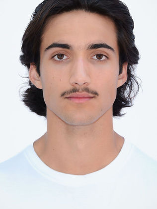 Headshot of male model with dark hair and mustache