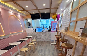 NY Tea Leaf store location. With a pink, whie, and gold interior.