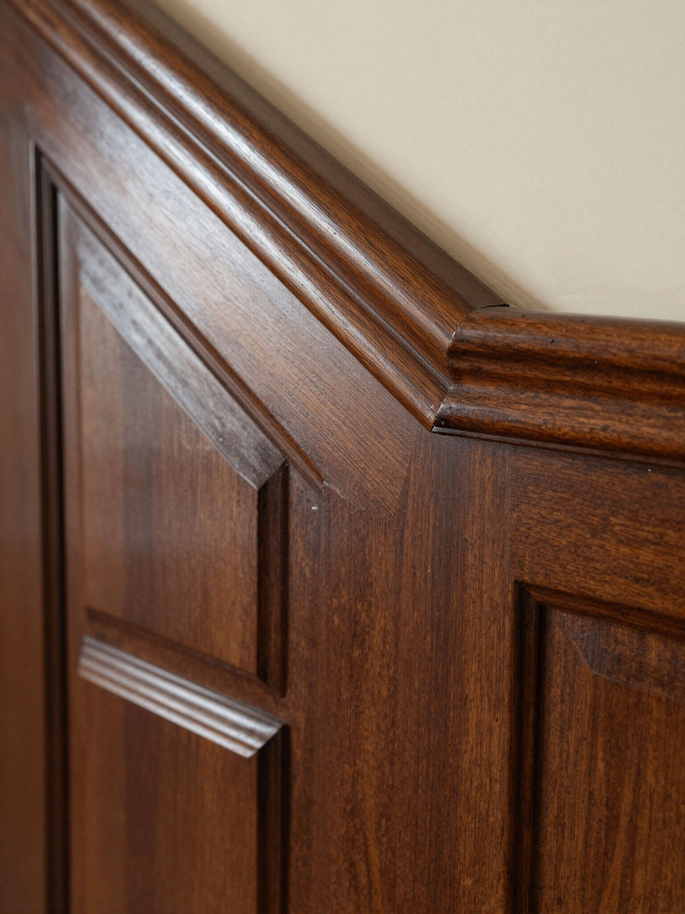 Dark wood paneling with decorative trim