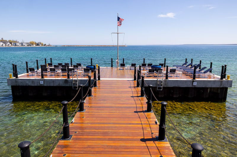 Dock with event seating on clear lake, American flag