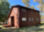 Brown two-story house with a small porch