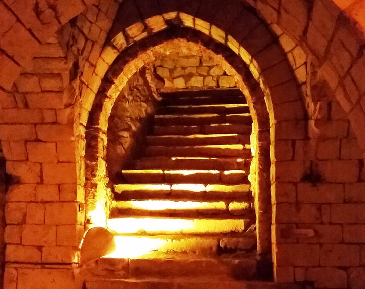 A set of stone steps leading up to a tunnel