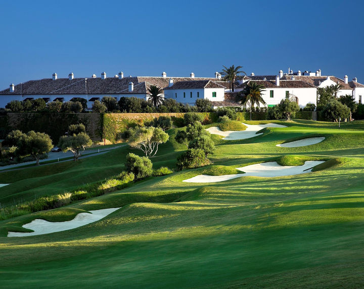 A view of a golf course with a building in the background