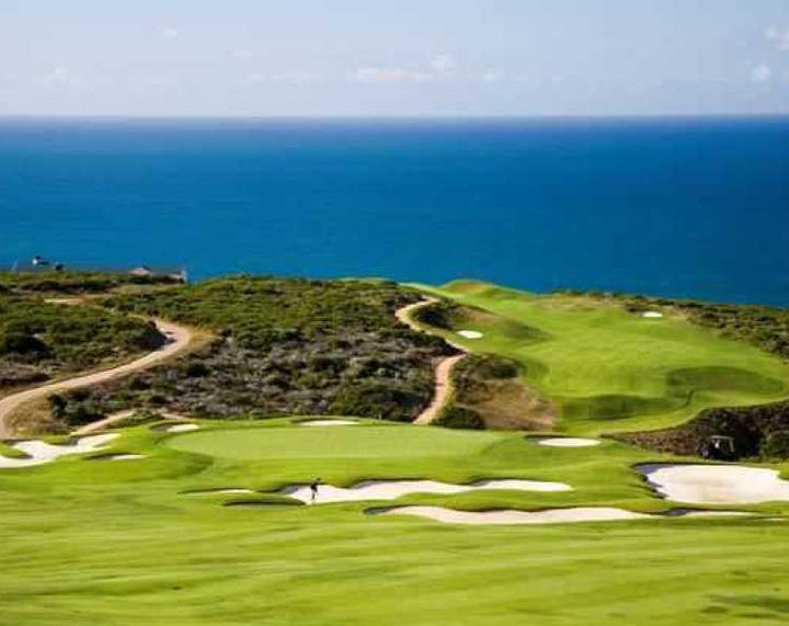 A golf course with a view of the ocean