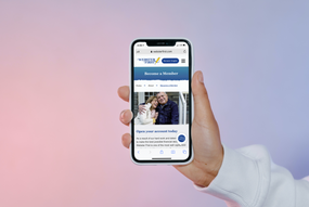 iPhone 11 in the hand of a man_BecomeAMember_screenshot.png