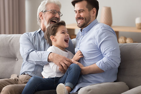Happy grandfather and father tickling little boy, three generations of men having fun toge