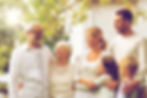 family, happiness, generation, home and people concept - happy family standing in front of