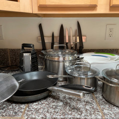 Pots and pans, mixing bowls, grater, knives, strainer