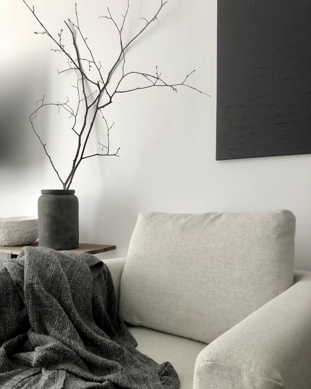 Minimalist interior with armchair and branches