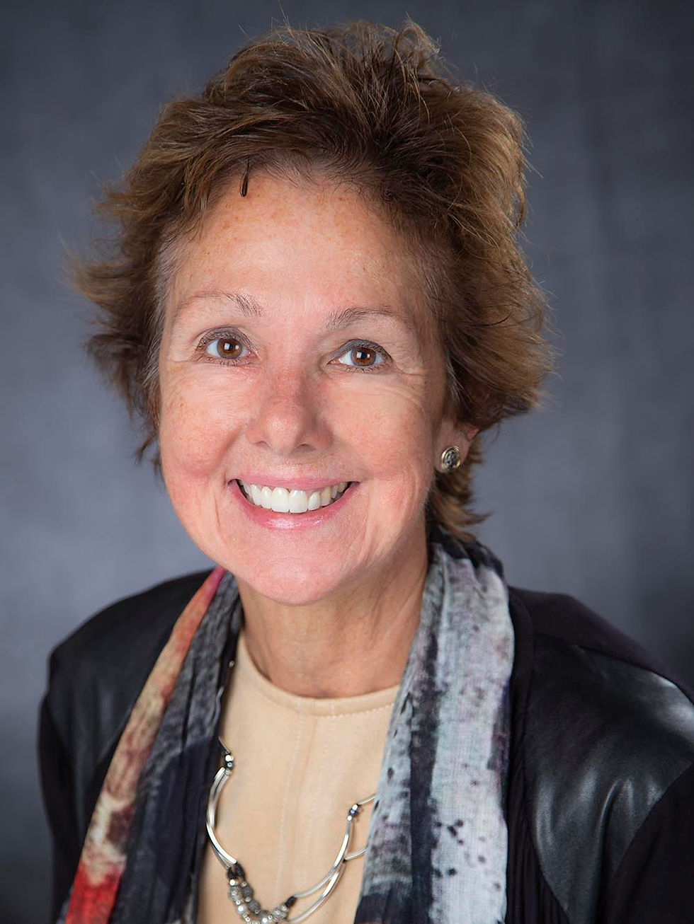 Smiling woman on Advisory Board with short brown hair
