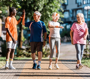 happy multicultural retired men giving high five in park near senior women.jpg