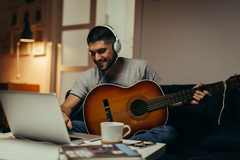 young man practice to play guitar at his