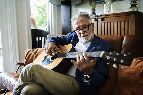 An elderly man is playing guitar.jpg