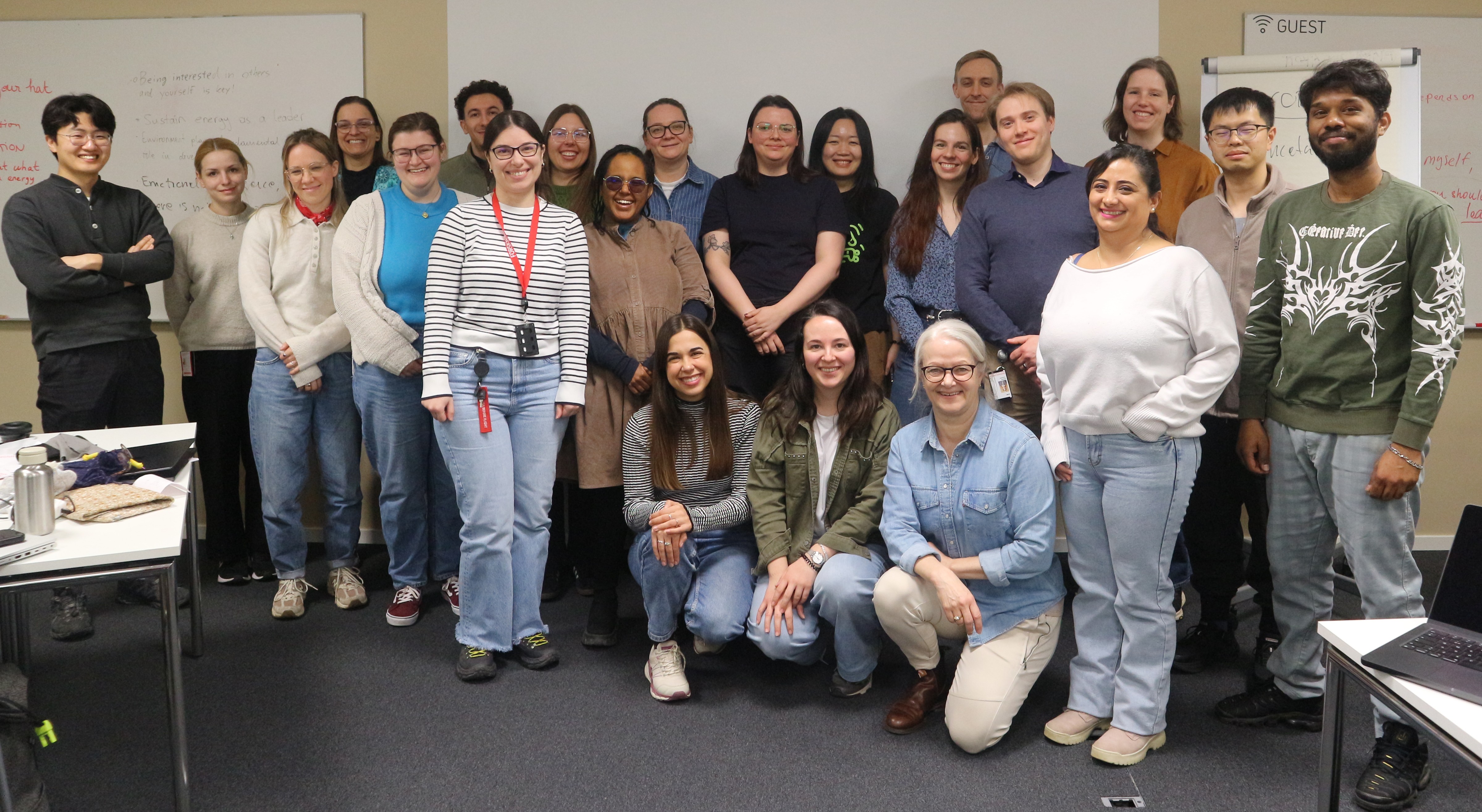 Group picture of the participants; 3 of them are kneeling at the front and the others are standing up.