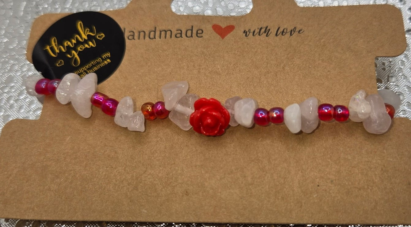 Handmade rose quartz beaded bracelet with red rose charm
