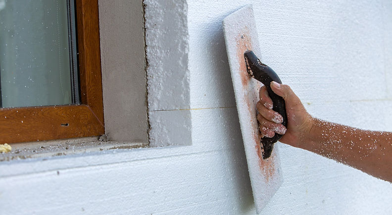 hand-worker-with-tool-sanding-making-smooth-even-surface-house-wall-insulated-with-styrofo