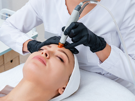 Woman receiving a professional hydrodermabrasion facial to refresh her skin for summer