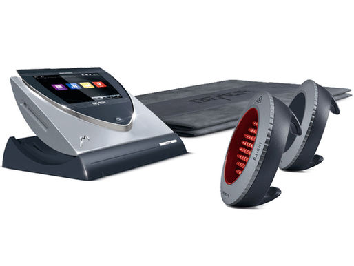 BEMER device with display and two circular, red-lit components; set on a gray mat with branding. Modern and sleek design.