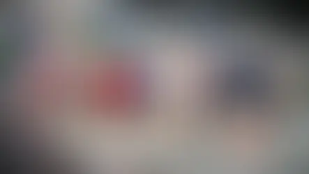 Teilnehmerinnen und Teilnehmer des Sparkassen Businesslaufs am Red Bull Ring bei schwierigen Wetterbedingungen mit Regen und Wind.