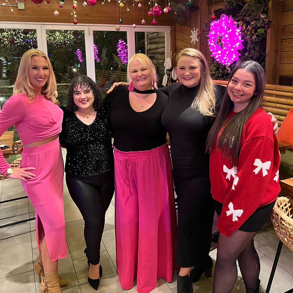 Corporate event planners collaborating behind the scenes at a stylish event venue while coordinating logistics, guest experience, and event details for a successful corporate gathering.