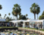 Eye-level view of outdoor garden block filled with colorful sculptures and paintings displayed by artists
